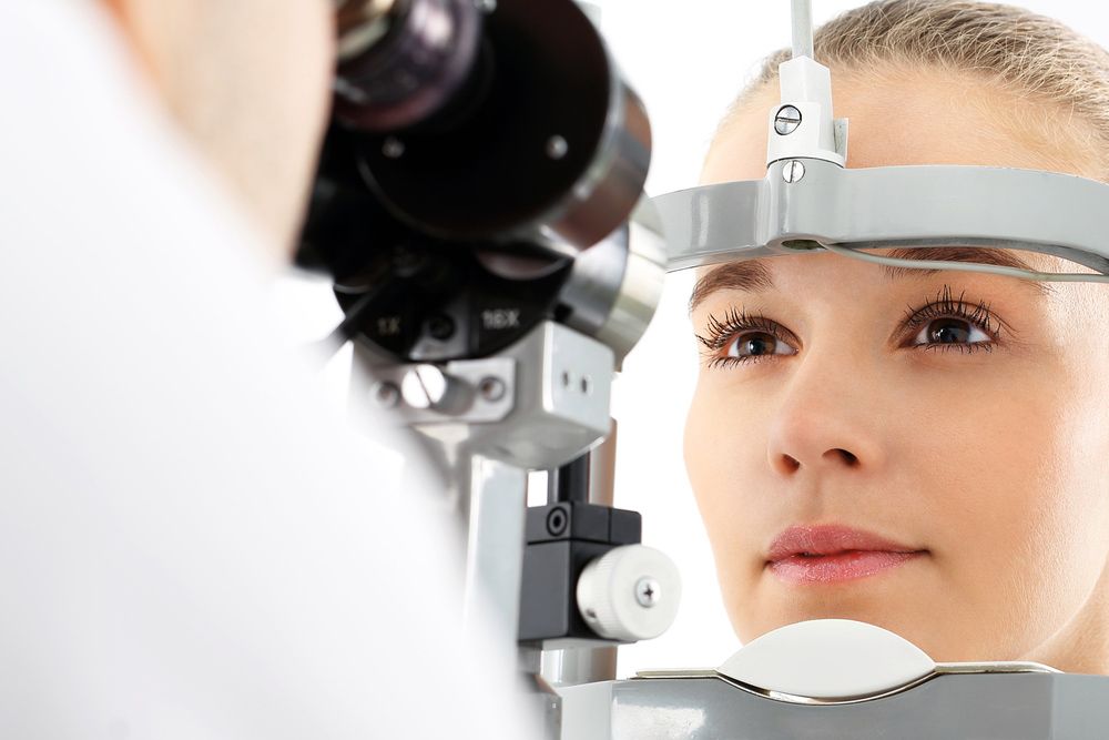 A Woman Is Getting Her Eyes Examined by An Ophthalmologist — John Williams Optometrist in Grafton, NSW
