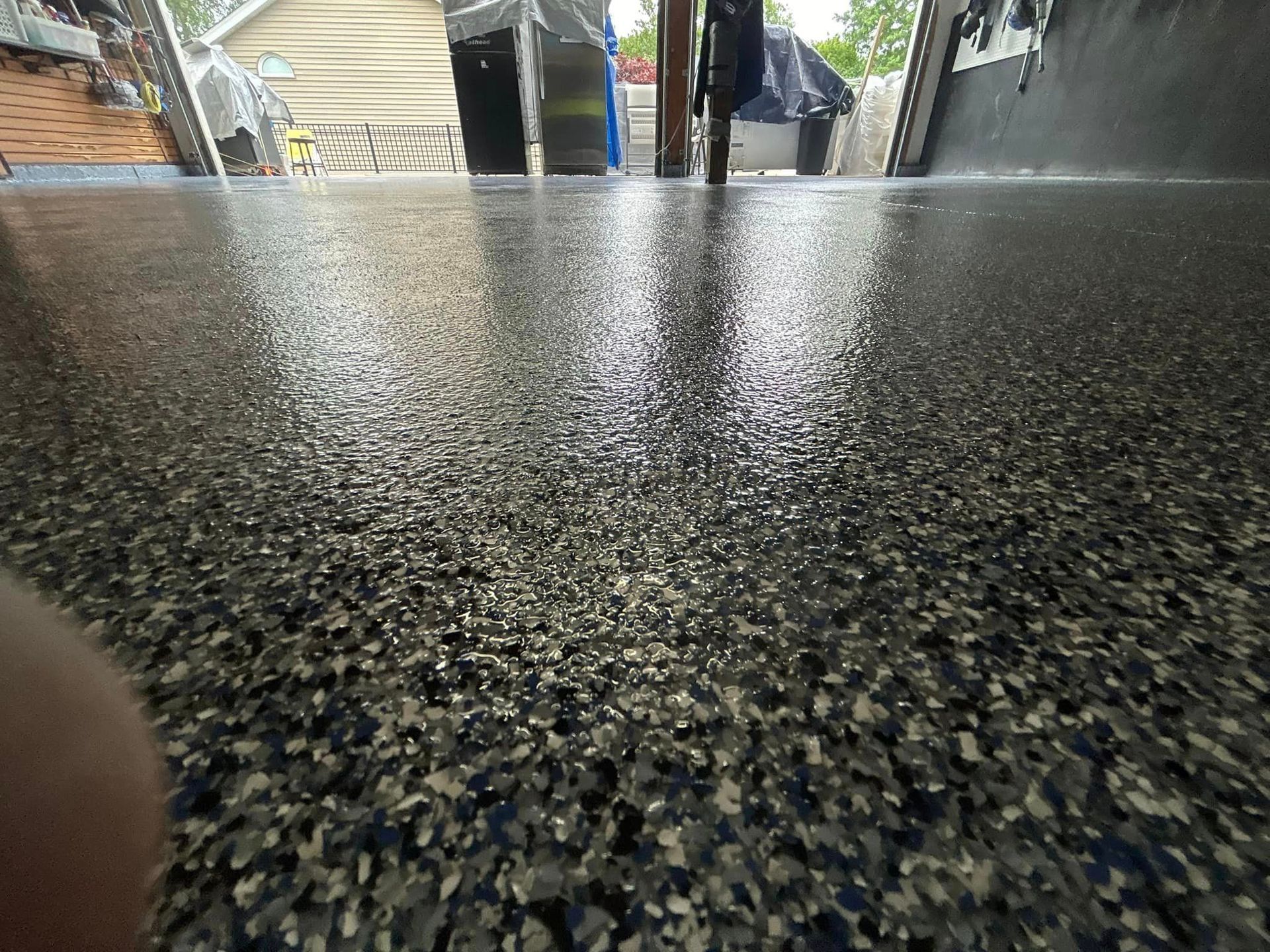 A garage with a gray floor and a garage door.