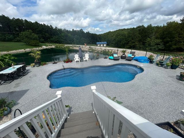 A large swimming pool with stairs leading to it