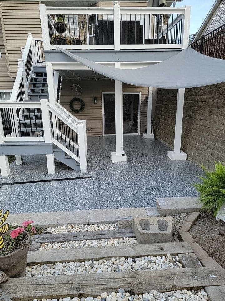 The backyard of a house with a deck and stairs.