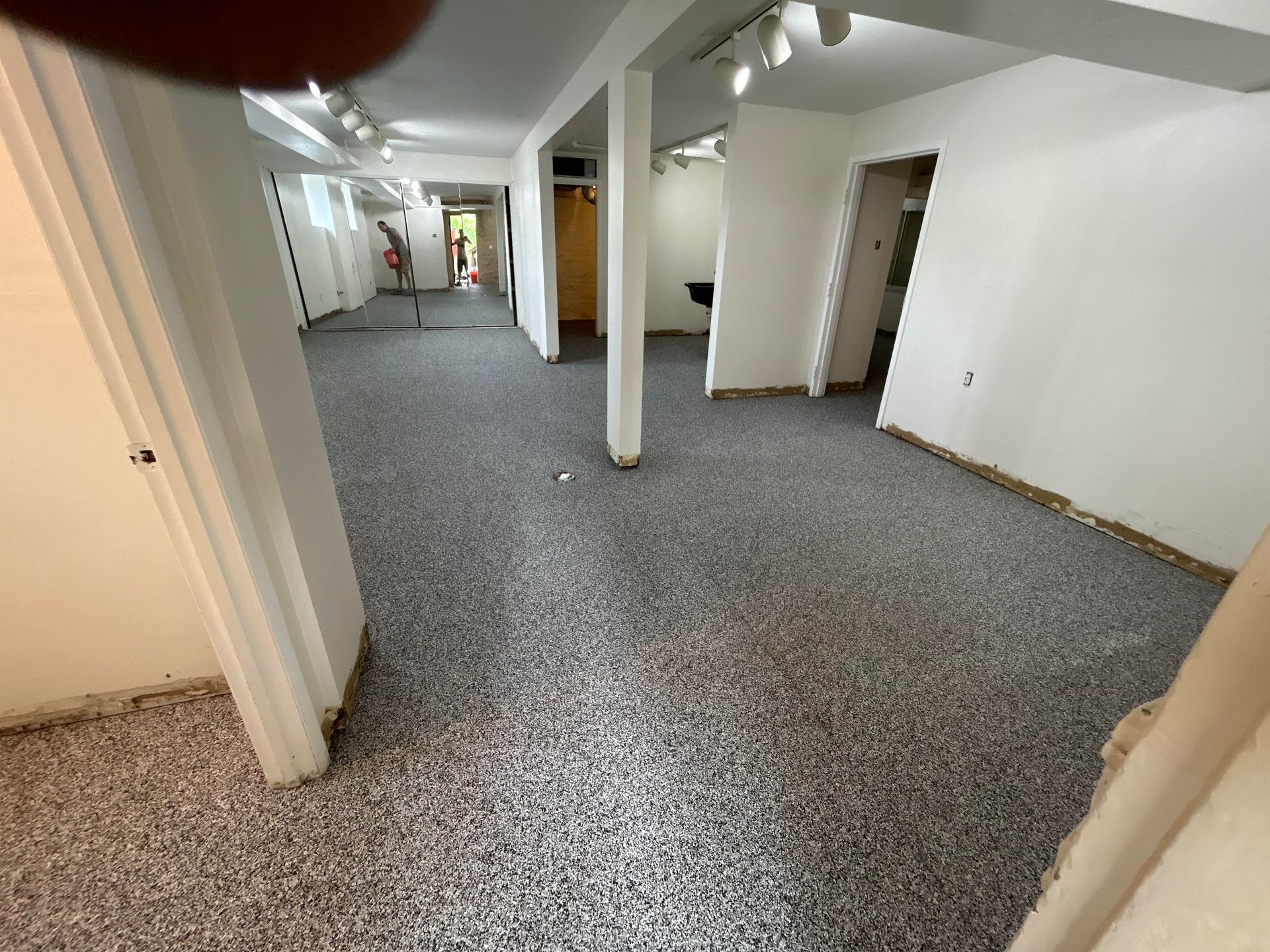 A large room with a gray floor and white walls