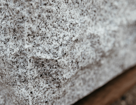 A close up of a piece of granite sitting on top of a wooden table.