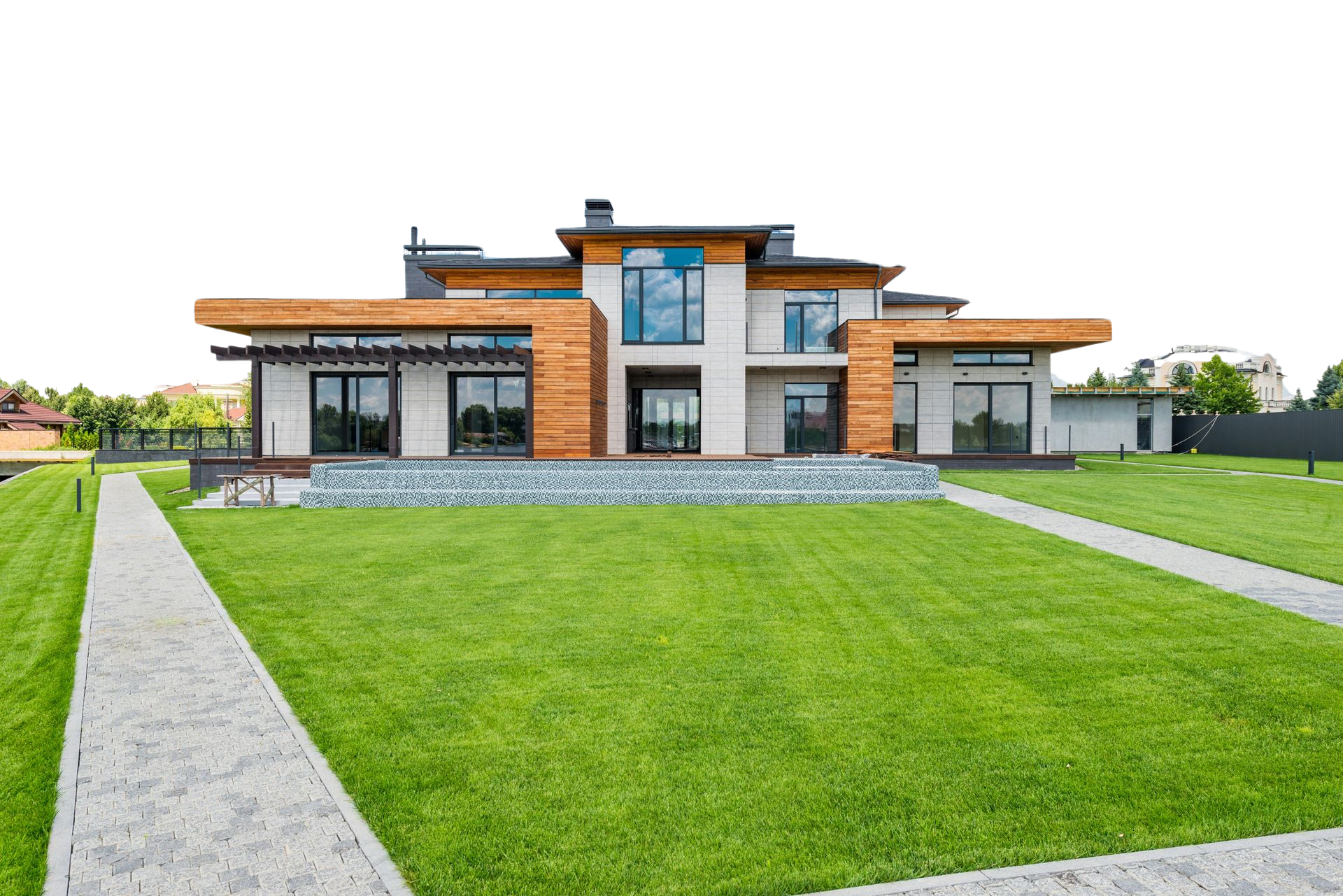 A large house with a lush green lawn and a walkway leading to it.