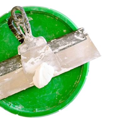 A spatula is sitting on top of a green bucket