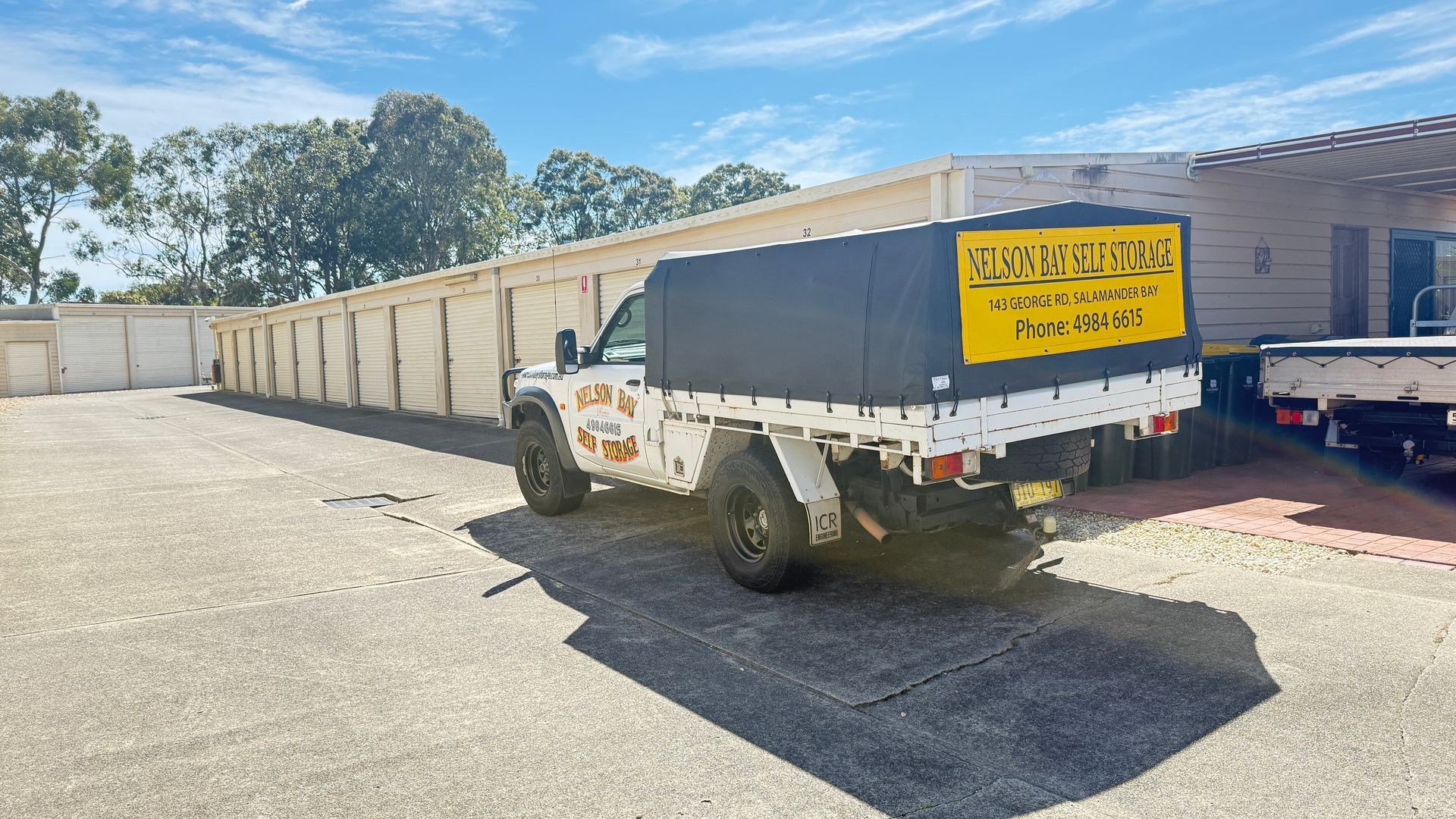 White Pickup Truck with A Covered Bed Parked Outside Storage Units — Nelson Bay Self Storage in Salamander Bay, NSW