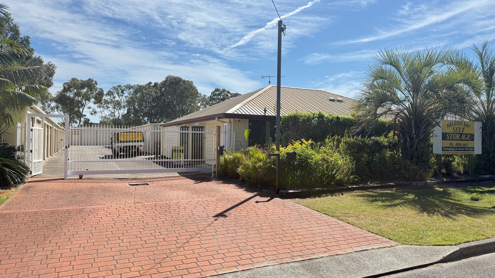 Brick Driveway Leading to A One-Story Building with A Sign — Nelson Bay Self Storage in Salamander Bay, NSW