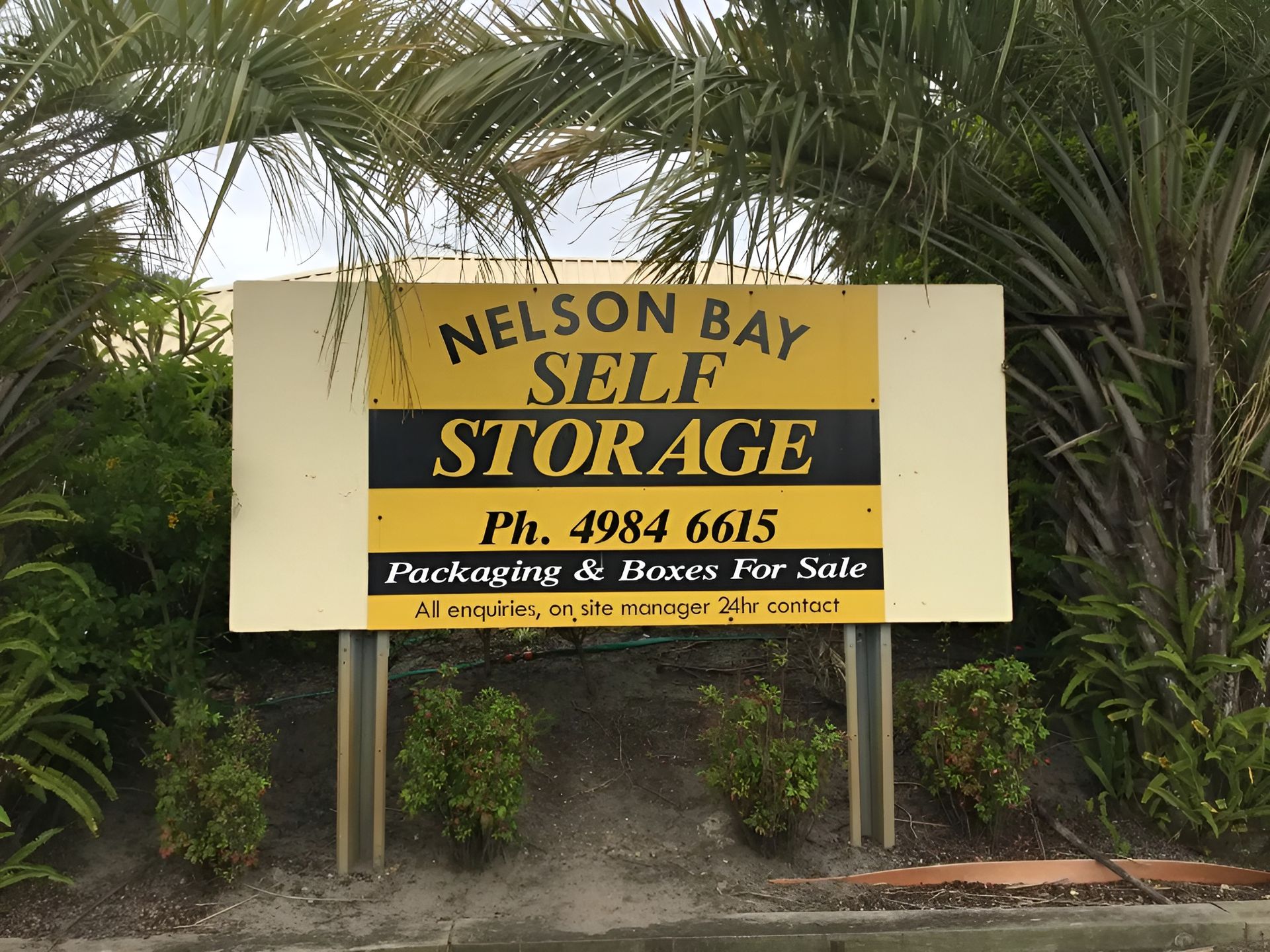 Sign for Nelson Bay Self Storage, Yellow and Black Text on A Tan Background — Nelson Bay Self Storage in Salamander Bay, NSW