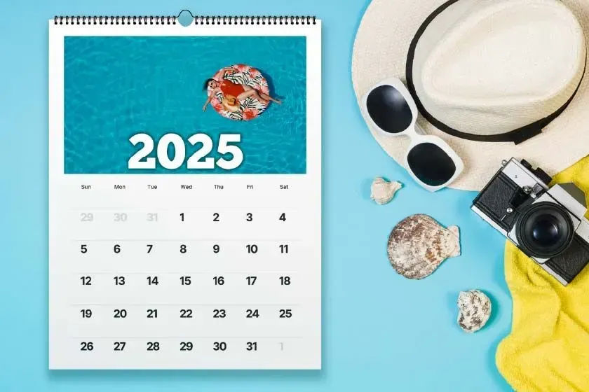 A calendar with flowers on a wooden table