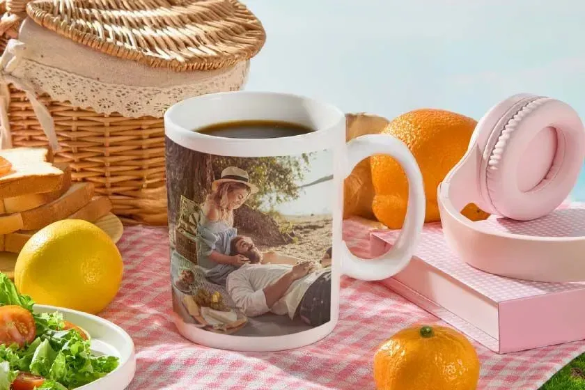 A white coffee mug with a picture of a man and a woman on it