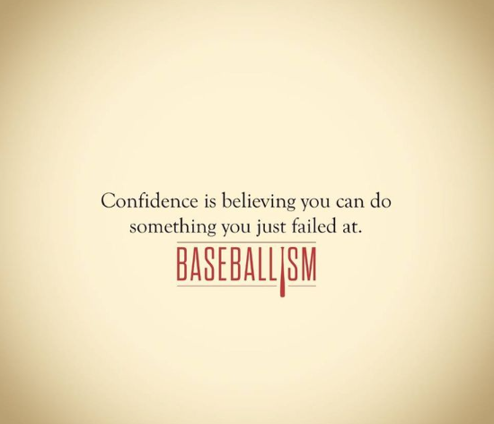 Baseball player sliding into base as another player attempts to catch the ball.