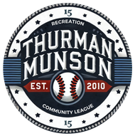 Baseball glove with ball on green grass, with blurred baseballs in the background.