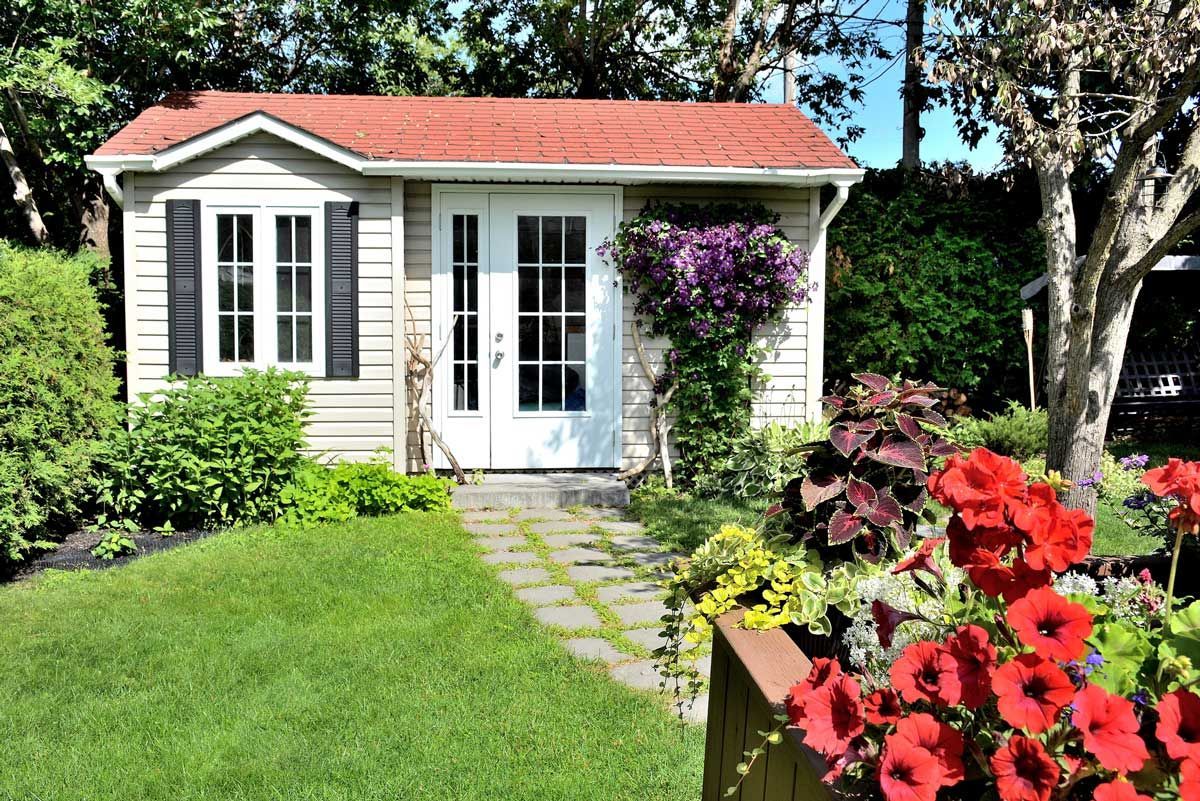 A white wooden utility shed with a red tiled roof | Utility Shed Dealer Wakulla County FL, Parkway Wrecker Service