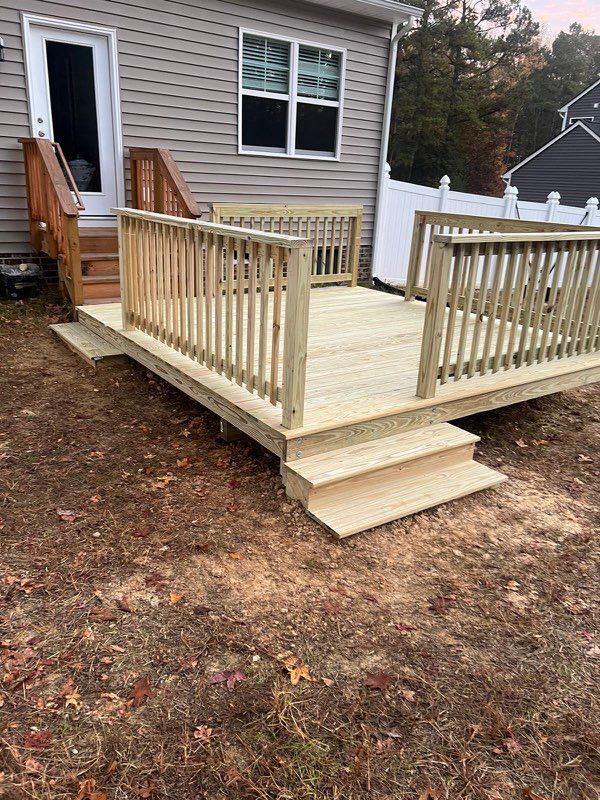Wooden deck with stairs leading down to a yard; the deck has railings.