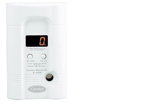 A white carrier co alarm with a digital display on a white background.