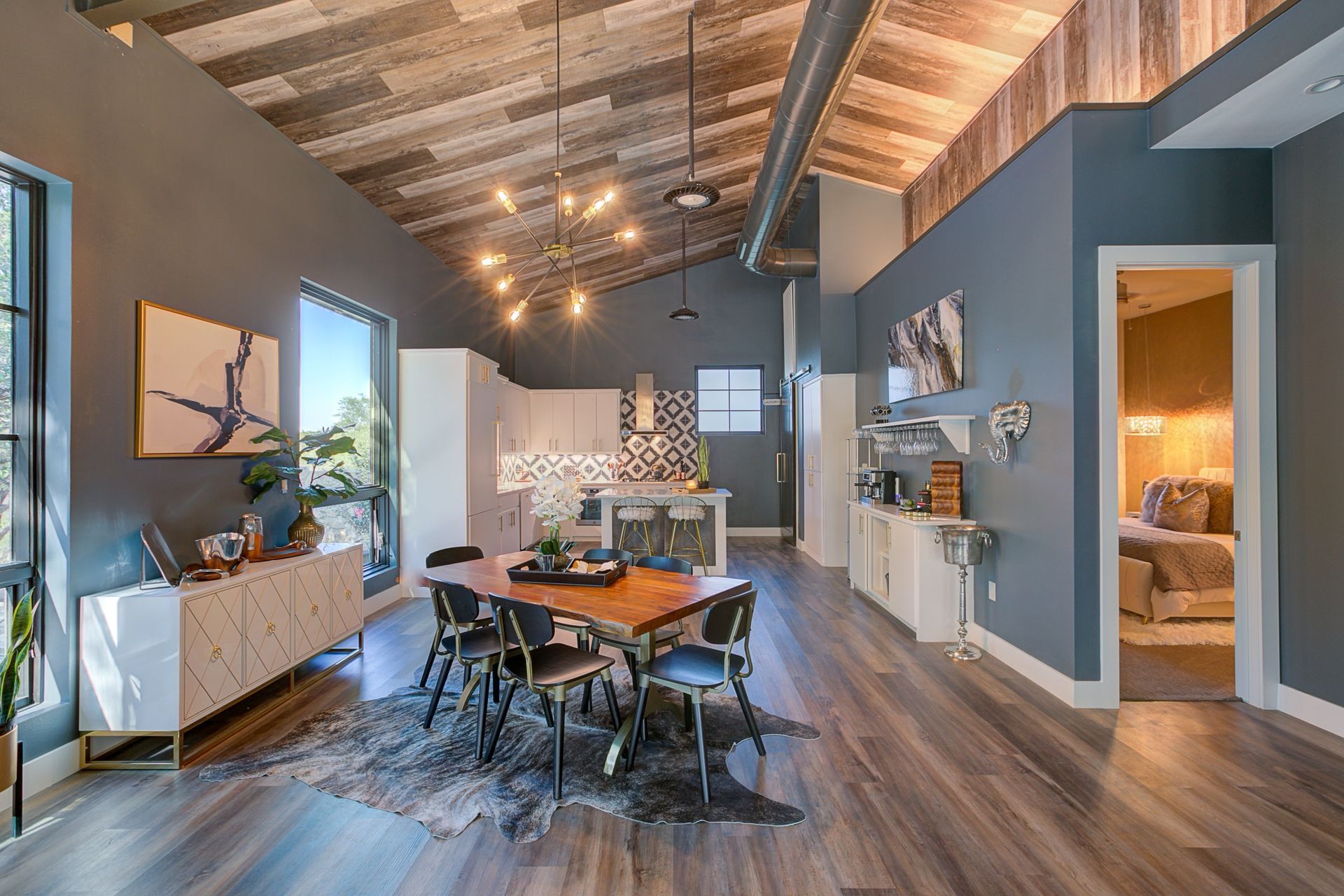 There is a dining table and chairs in the middle of the room.