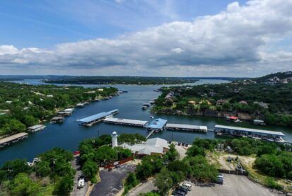 An aerial view of a large body of water surrounded by trees.