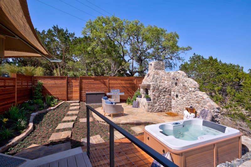 There is a hot tub in the backyard of a house.