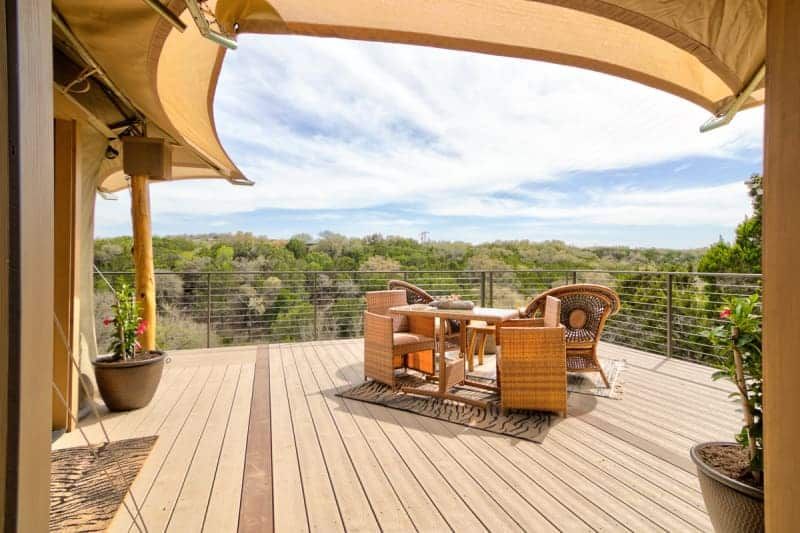 A wooden deck with a table and chairs on it.