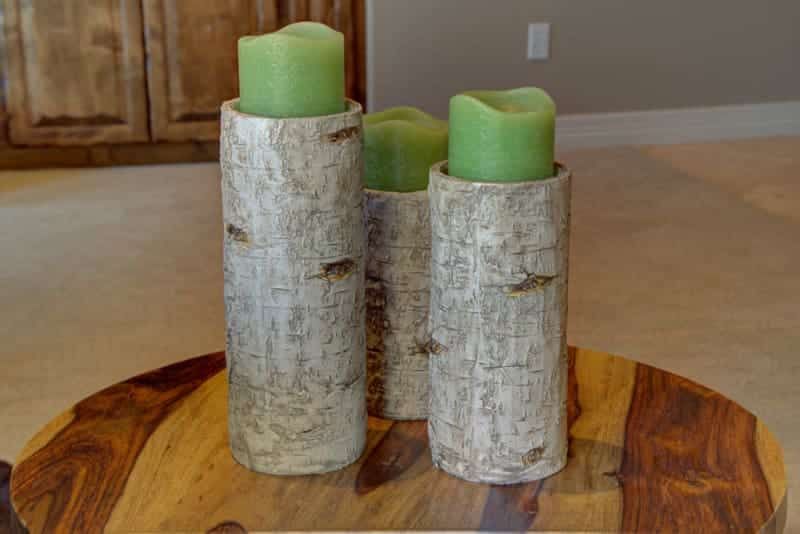 Three candles are sitting on a wooden table.