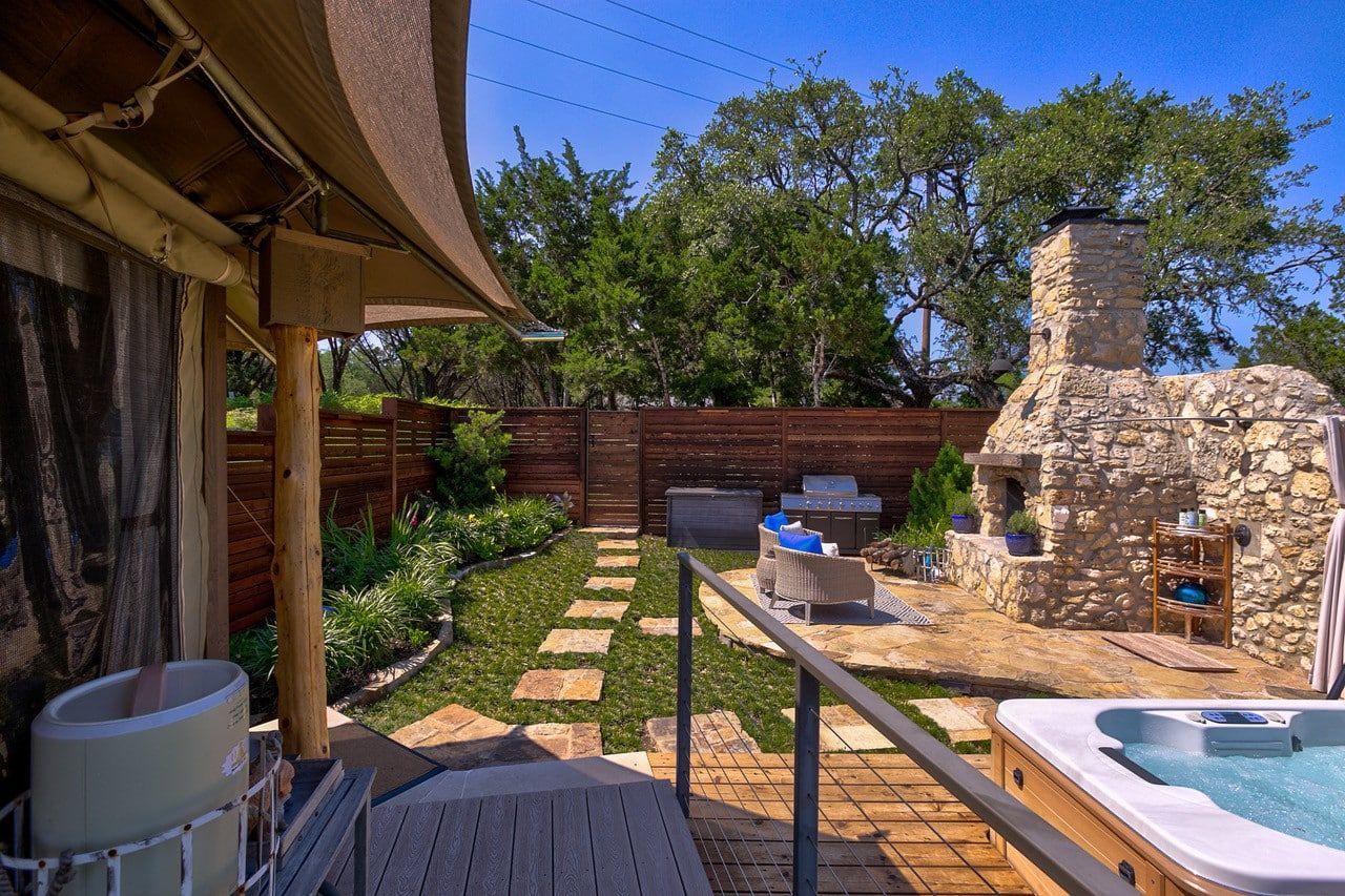 There is a hot tub in the backyard of a house.
