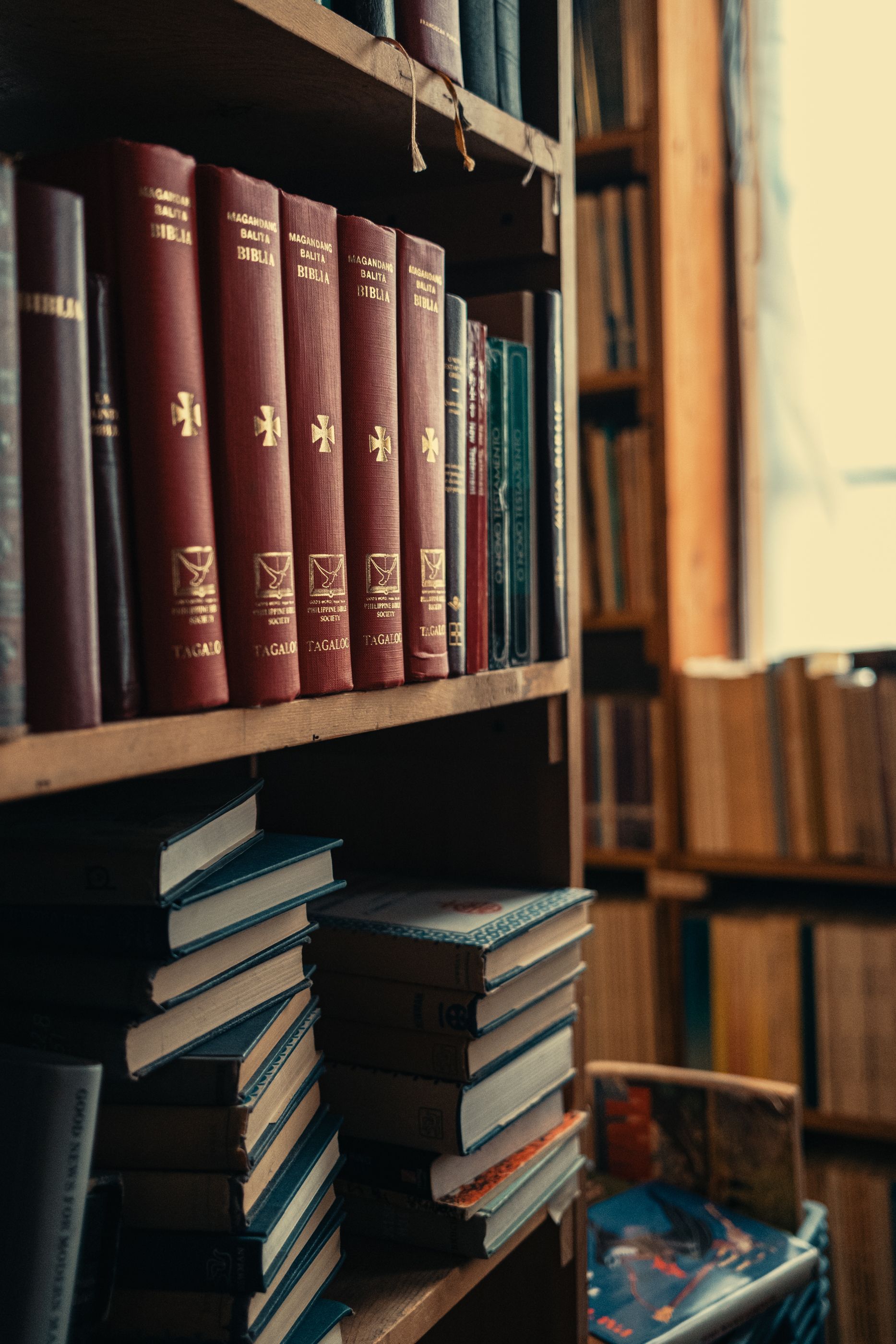 A bookshelf filled with lots of books in a library.