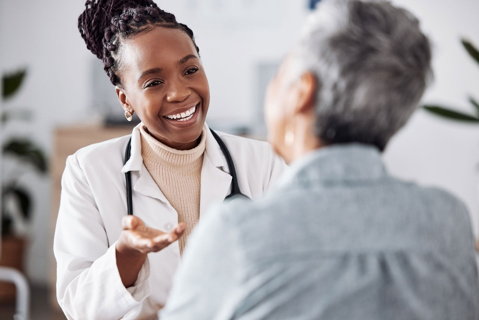 A doctor is talking to an elderly woman in a hospital.