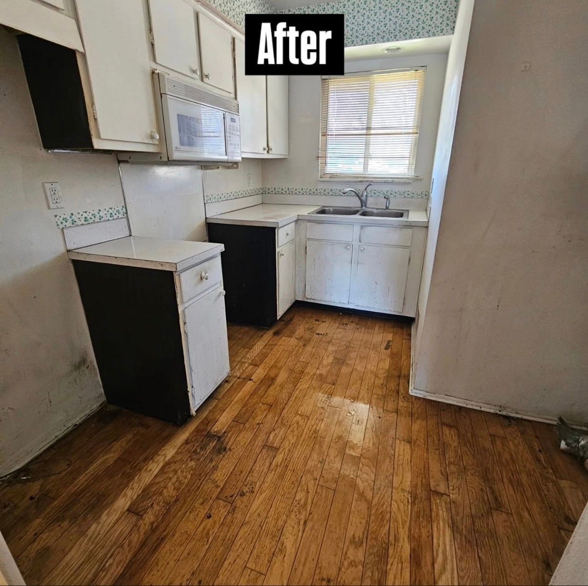 After: small renovated kitchen with white cabinets, wood floor, and a window over the sink.