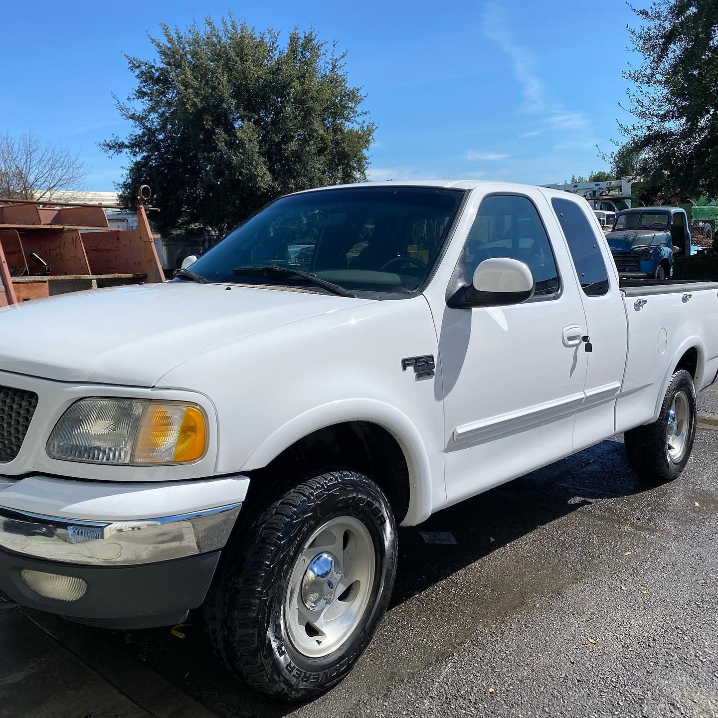 A white pickup truck is parked on the side of the road.