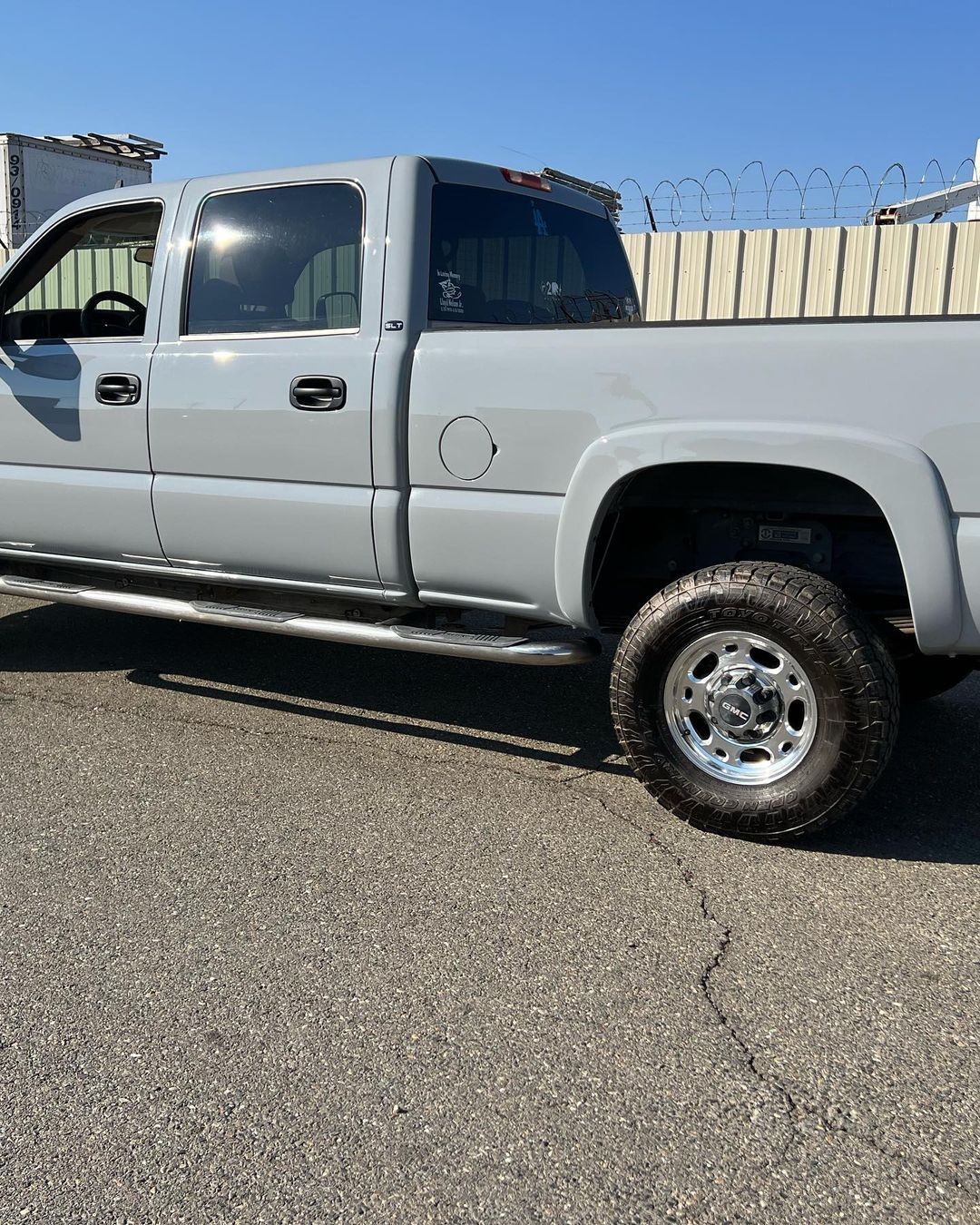 A white truck is parked on the side of the road.