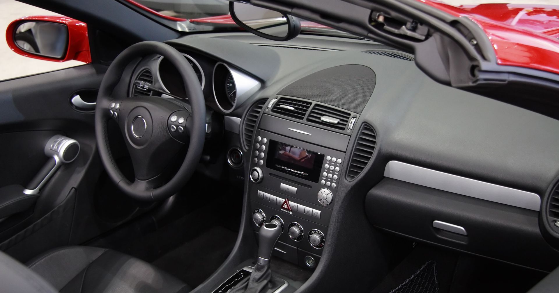 The dashboard of a red sports car The dashboard of a red sports car