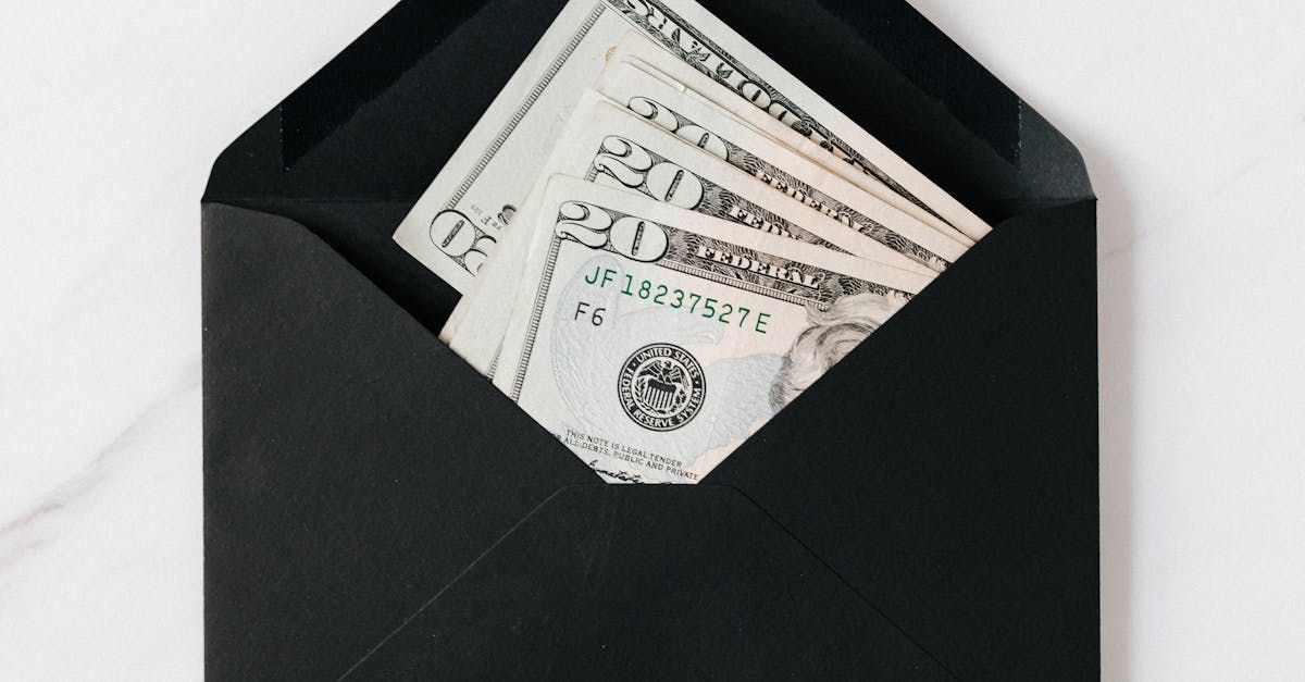 Several $20 bills in a black envelope