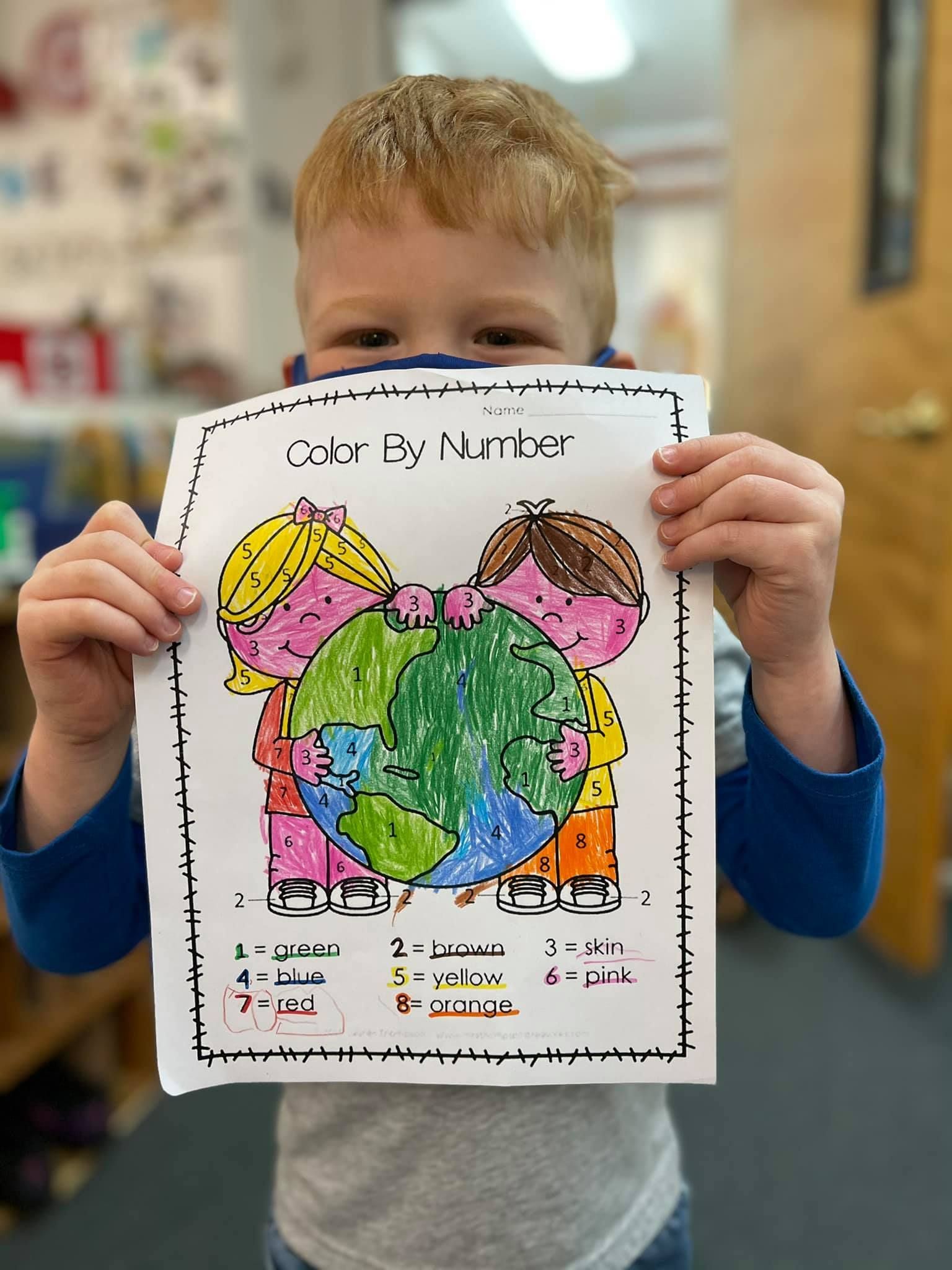 Young boy holding a colorful paper