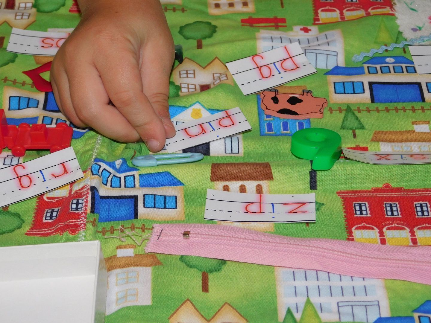 Child's hand placing word cards