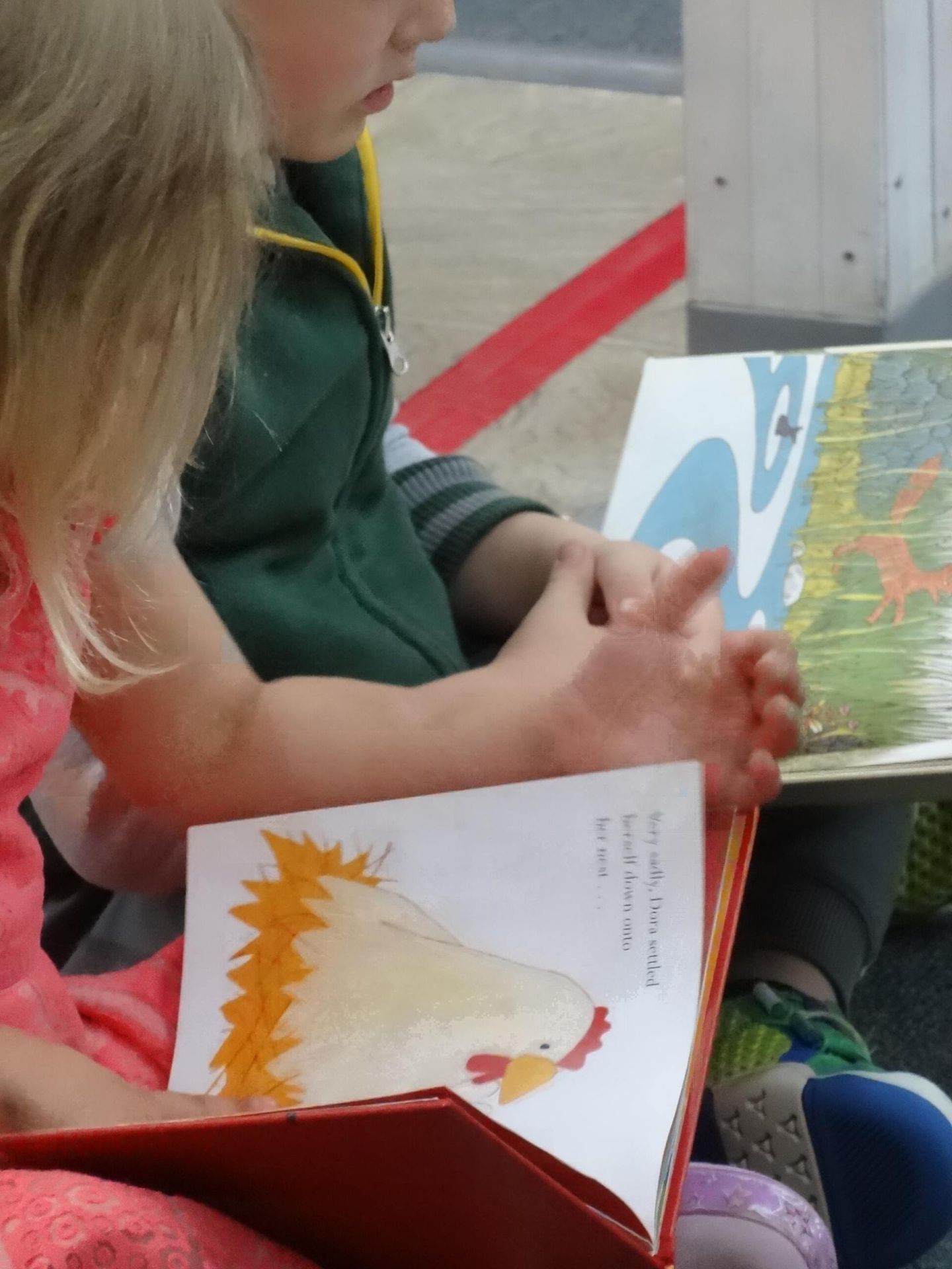 Two children reading picture books 