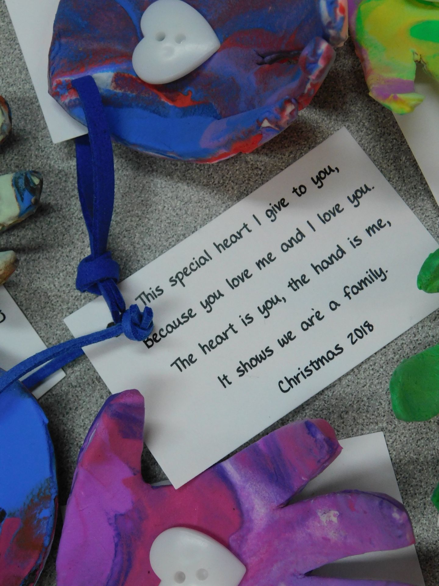 Handmade heart-shaped ornaments with attached tags bearing a poem