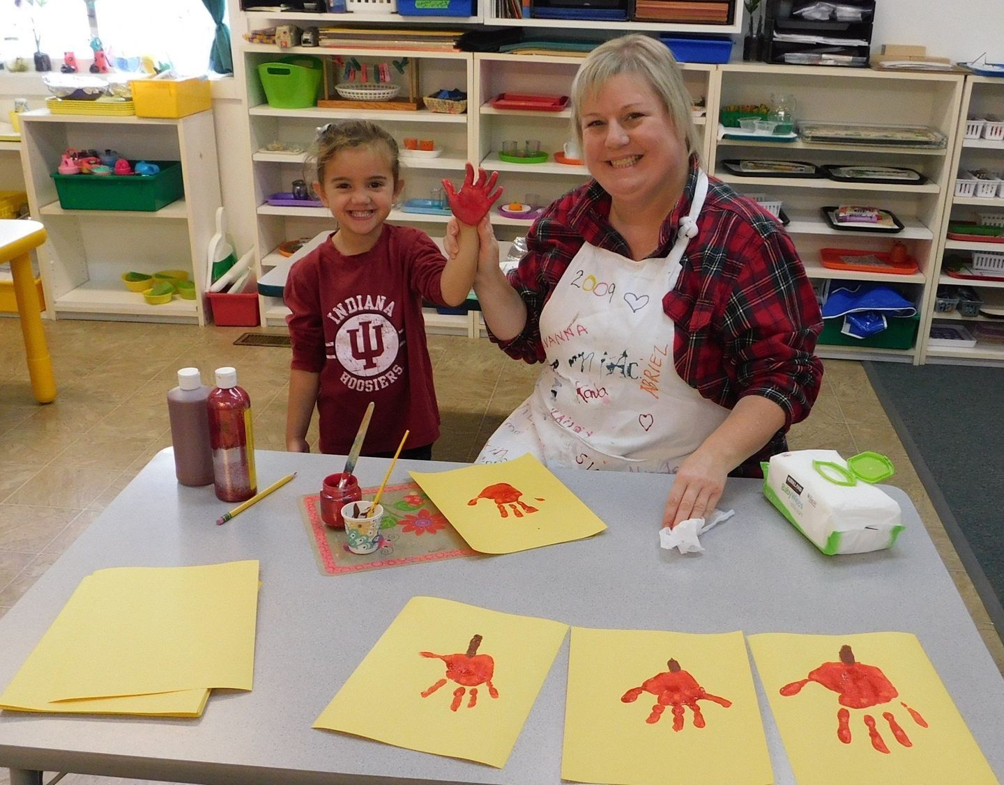 Woman and child making handprint art