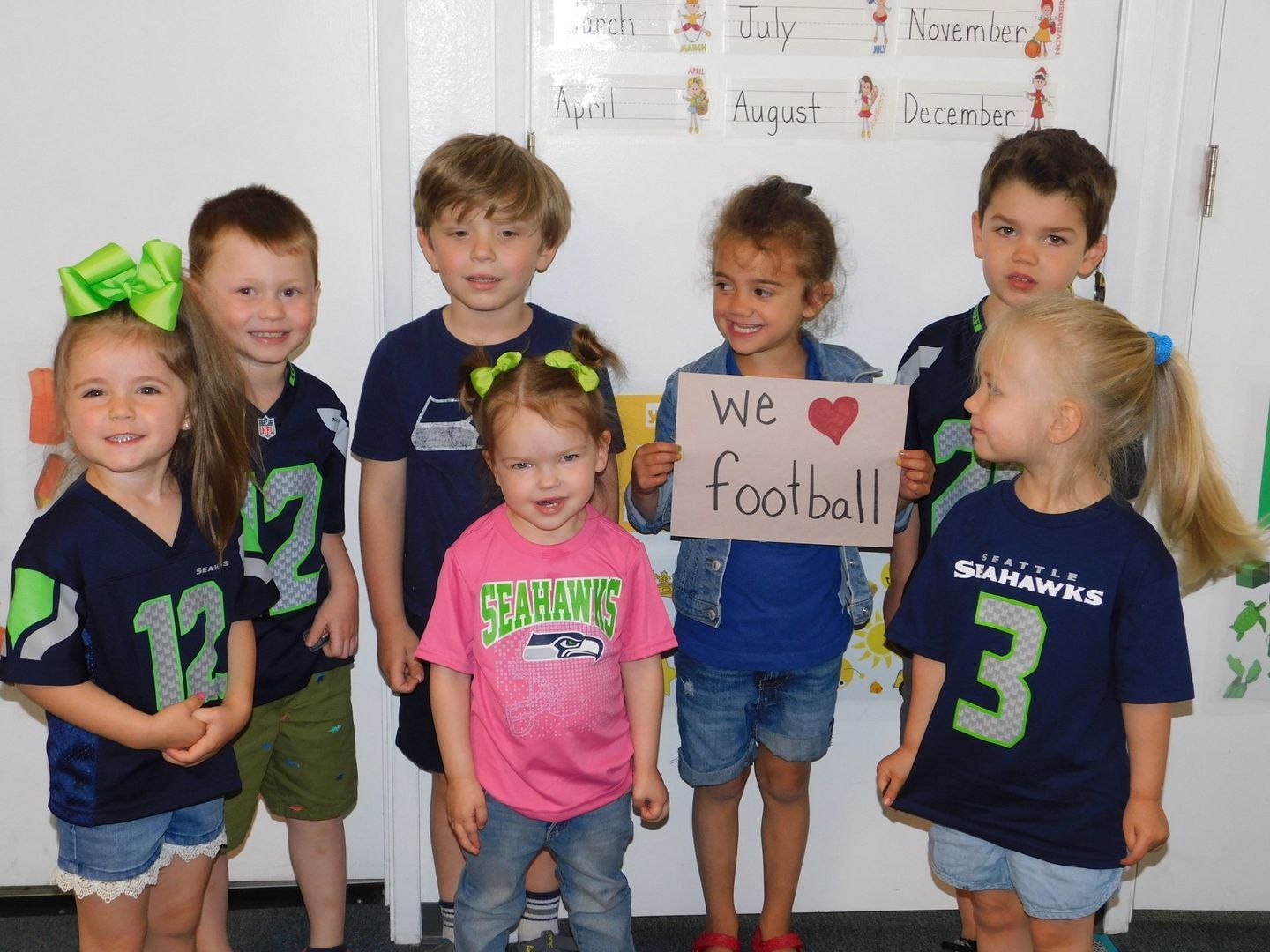 Group of children wearing Seattle Seahawks gear