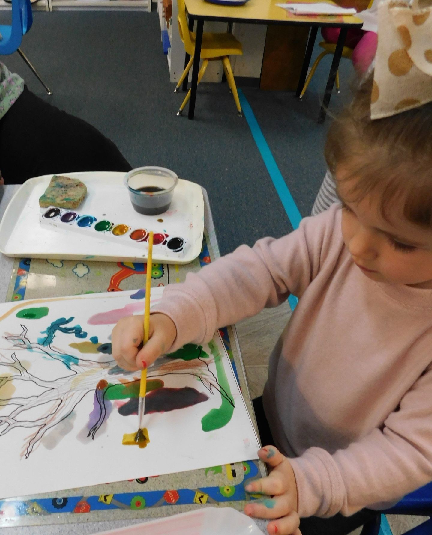 Young girl painting at a table