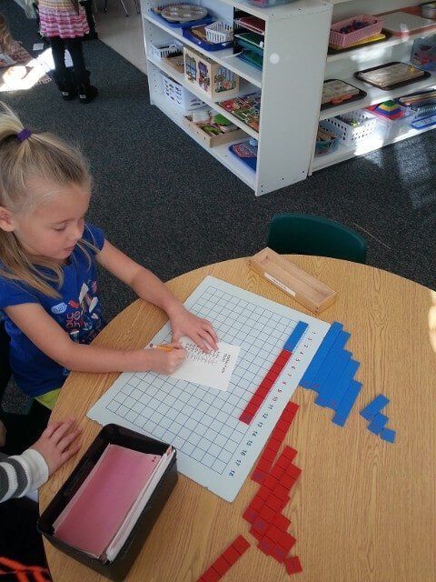 Girl at table writing