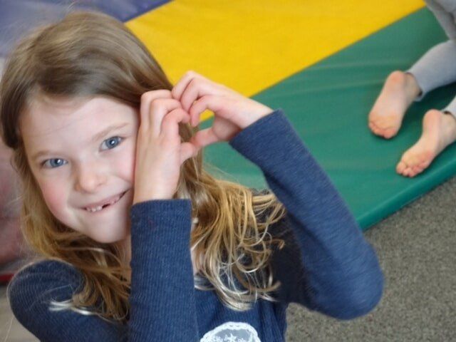 Girl making a heart shape with her hands