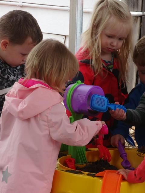 Children playing at a sand table
