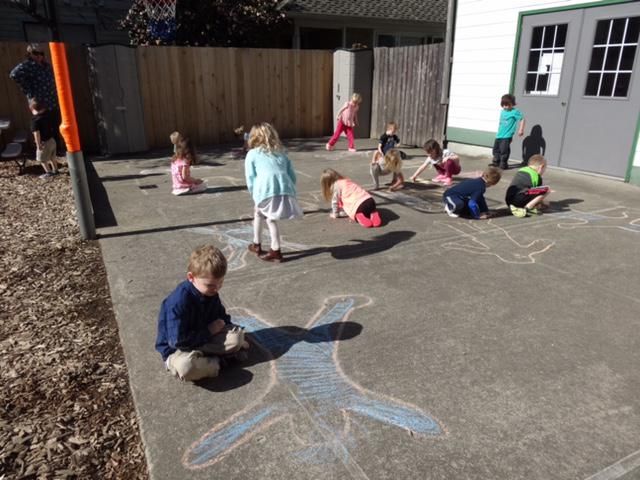 Children playing with chalk outdoors