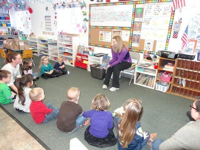 Teacher reads to children in a classroom