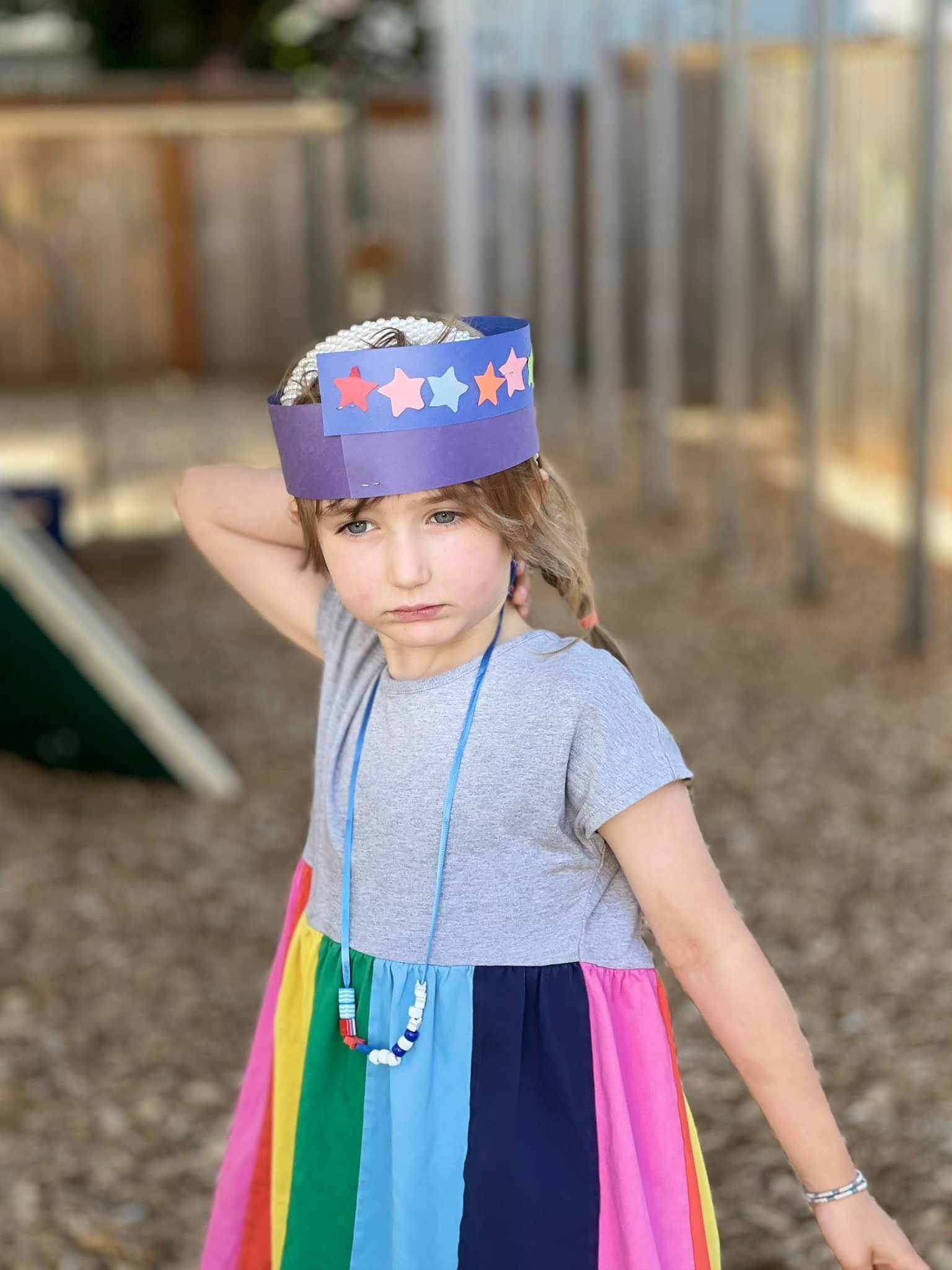 Girl in rainbow dress and star crown