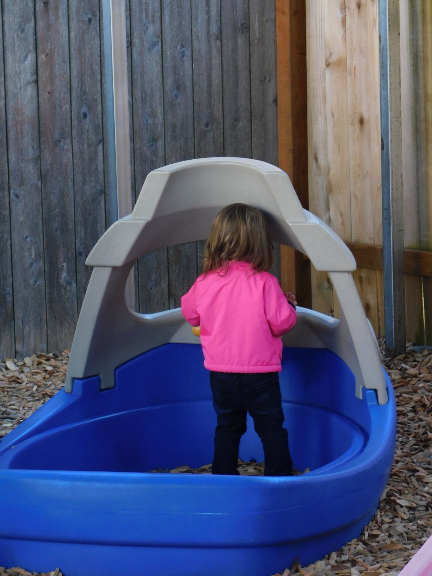 Child in a blue playhouse