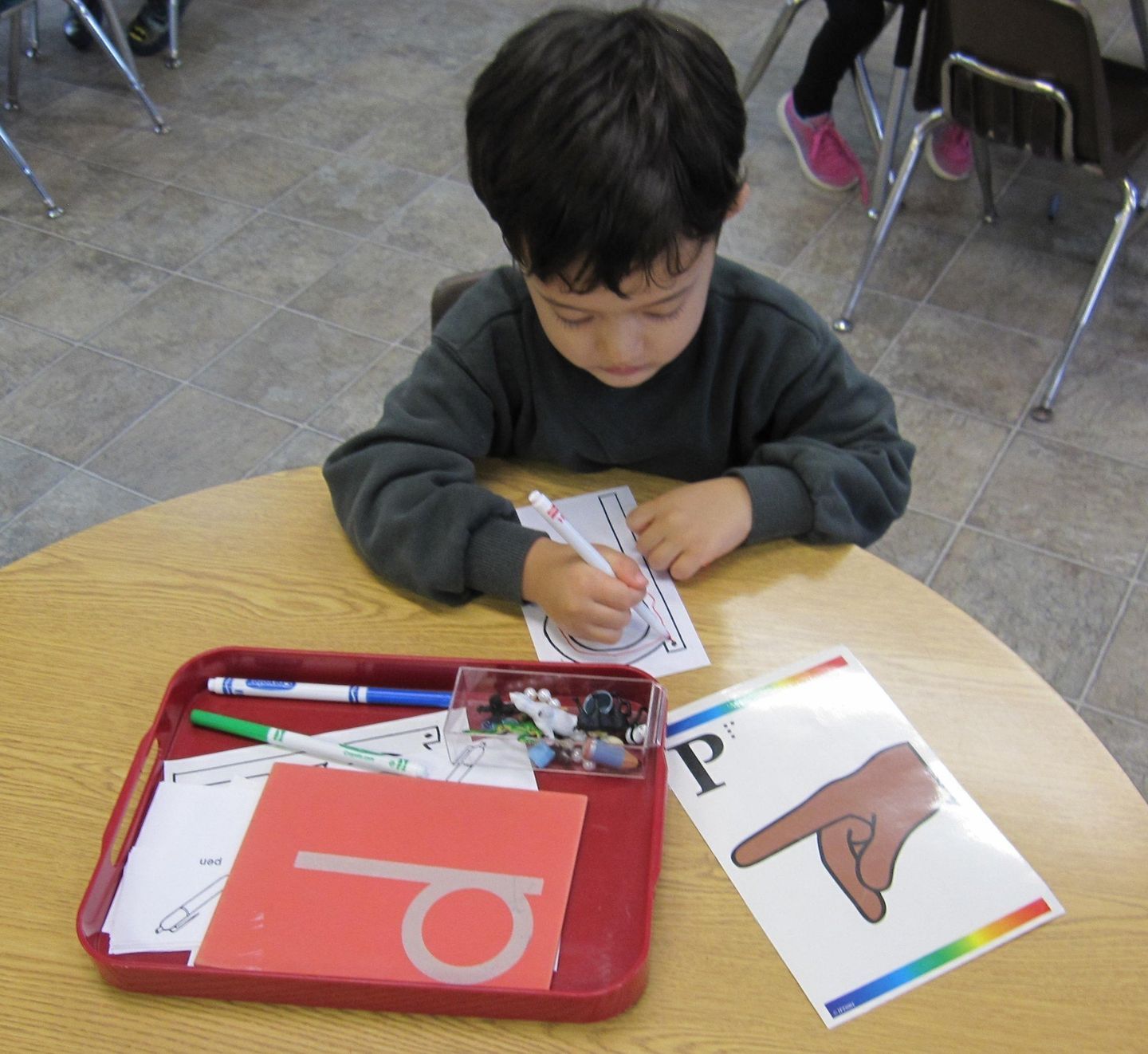 A young boy sits at a table