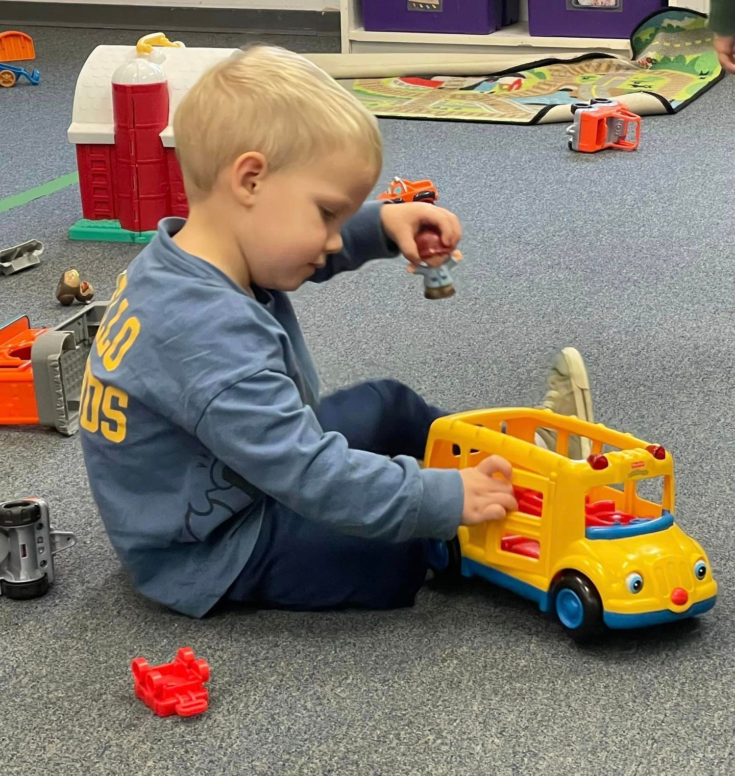 Young child sits on the floor