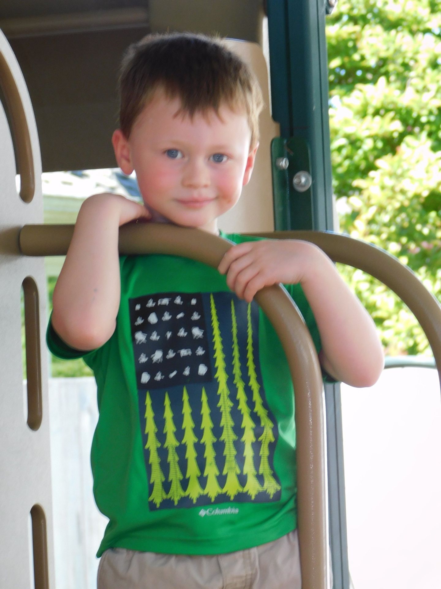 Boy with red hair and blue eyes in a green shirt