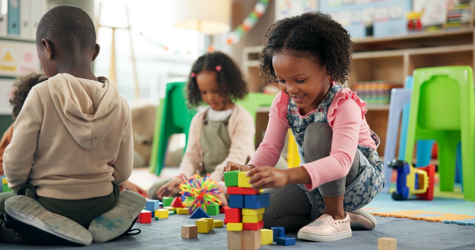 Children playing with blocks in a colorful classroom