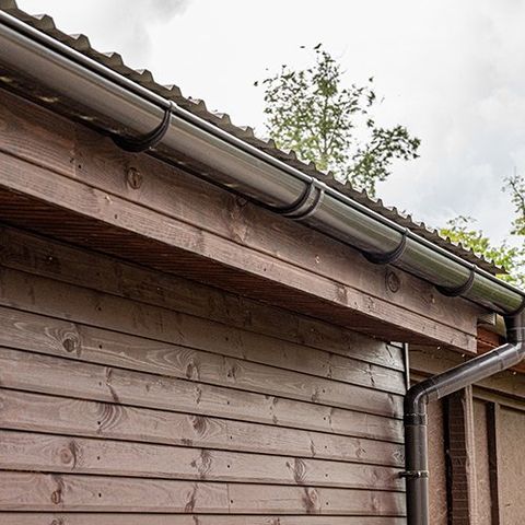Roof Edge Of A Small House With Installed Rainwater Drainage System — Your Craftsmen in Eleebana